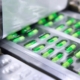 Medication being put into blister packaging by machine