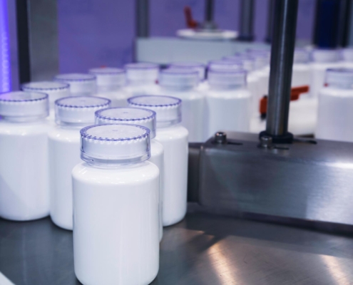 Bottles being filled in groups in factory